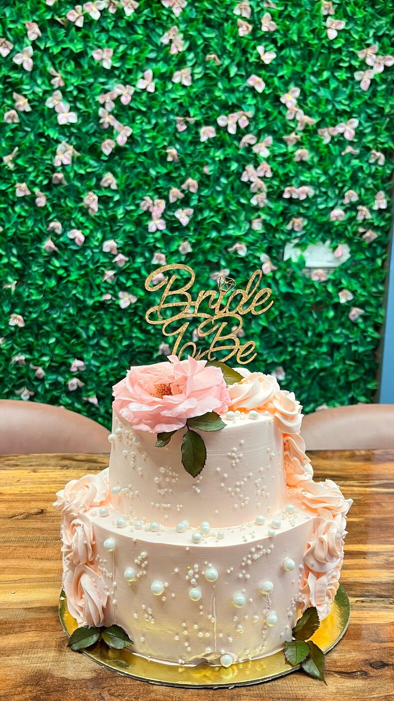 Two-tier engagement cake with fresh roses and a Bride To Be topper