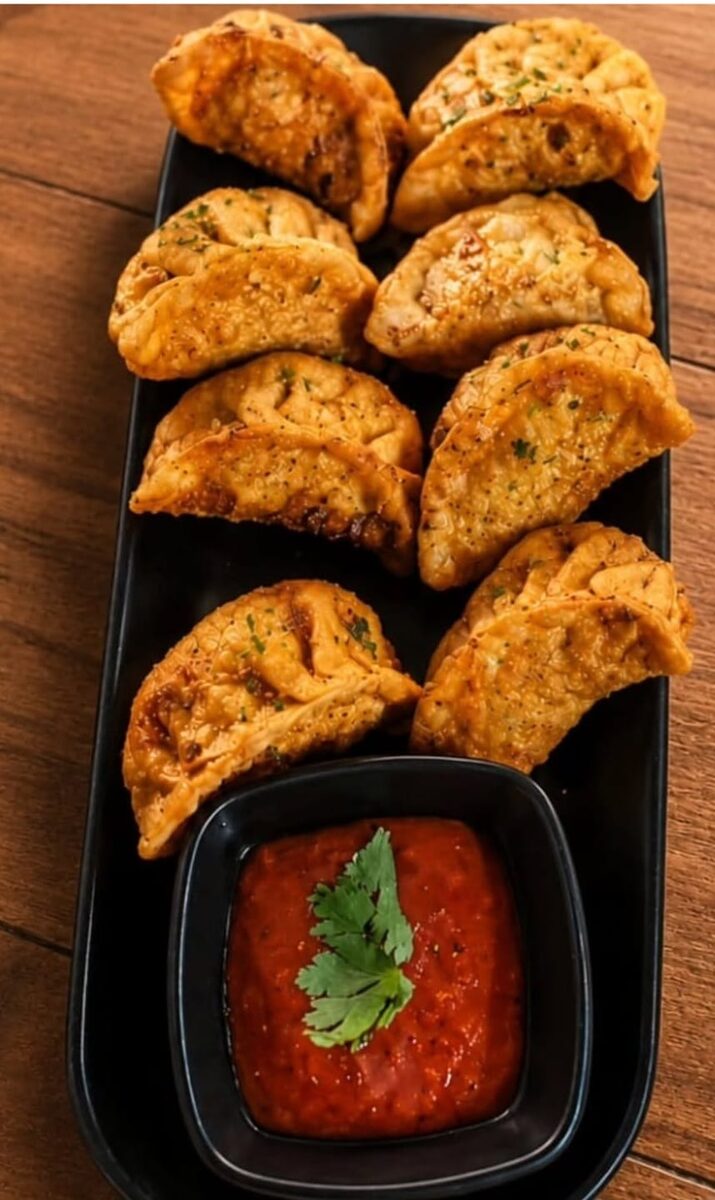 Crispy fried momos served with dipping sauce
